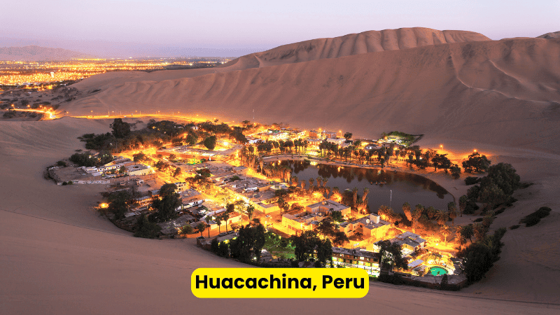 The desert oasis of Huacachina, Peru, surrounded by towering sand dunes and offering thrilling adventures